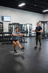 Athlete performing return-to-sport strength training with a physical therapist at a sports performance clinic in Henrico, VA