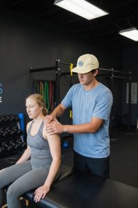 Patient working with a provider at a performance physical therapy clinic in Henrico, VA during a lower extremity strength exercise